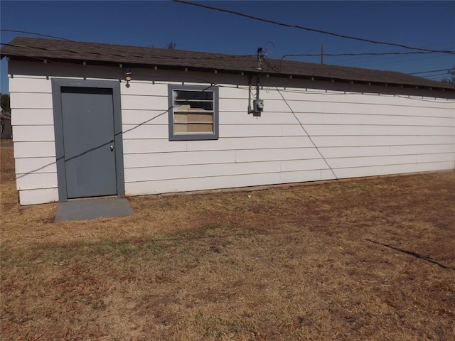 view of outbuilding featuring a yard