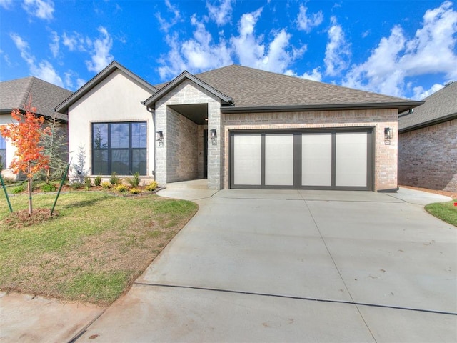 view of front of house with a garage and a front lawn