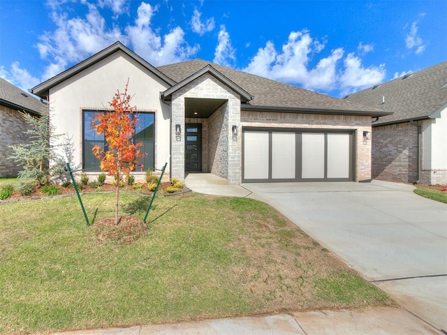 view of front of property with a front yard and a garage