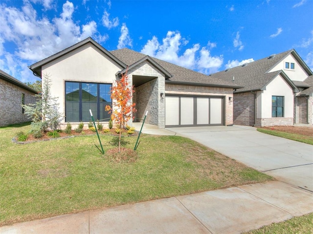 view of front of property with a front yard and a garage