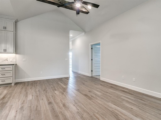 spare room featuring ceiling fan, light hardwood / wood-style floors, and high vaulted ceiling