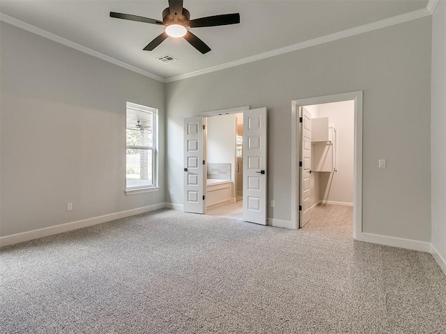 unfurnished bedroom featuring light carpet, a walk in closet, ceiling fan, and ornamental molding