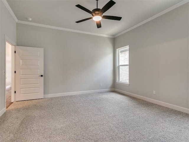 carpeted spare room featuring ceiling fan and ornamental molding