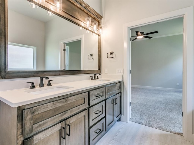 bathroom with ceiling fan, tile patterned flooring, and vanity