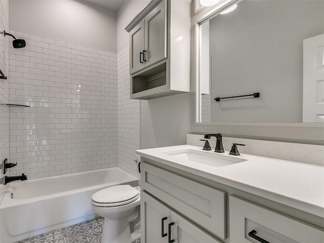 full bathroom featuring vanity, tiled shower / bath combo, and toilet