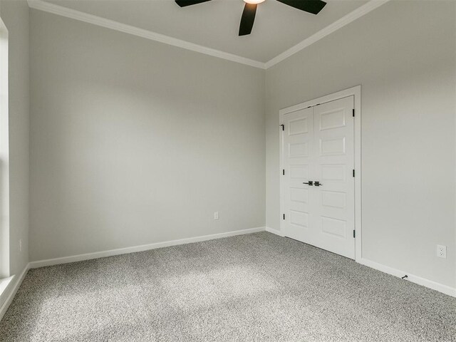 unfurnished room with ceiling fan, carpet floors, and crown molding