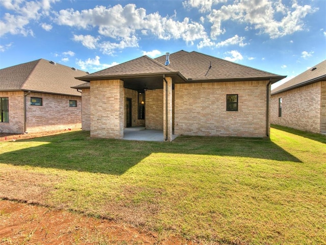 back of house with a patio area and a yard