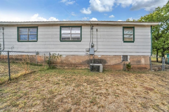 view of side of home with central air condition unit