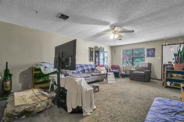 carpeted living room with ceiling fan and a textured ceiling