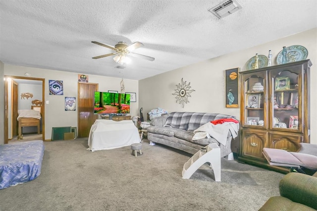 carpeted living room with ceiling fan and a textured ceiling