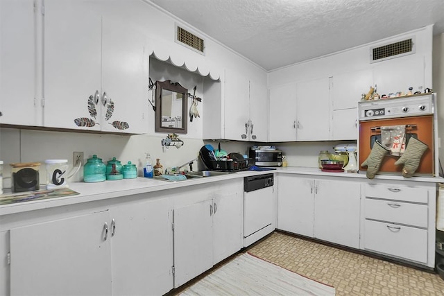 kitchen with white cabinets, dishwasher, oven, and a textured ceiling