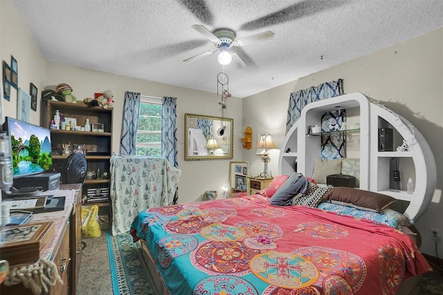 bedroom with ceiling fan, carpet, and a textured ceiling