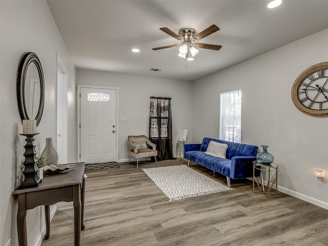 living room with hardwood / wood-style flooring and ceiling fan