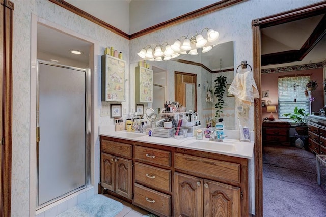 bathroom with vanity, crown molding, and walk in shower