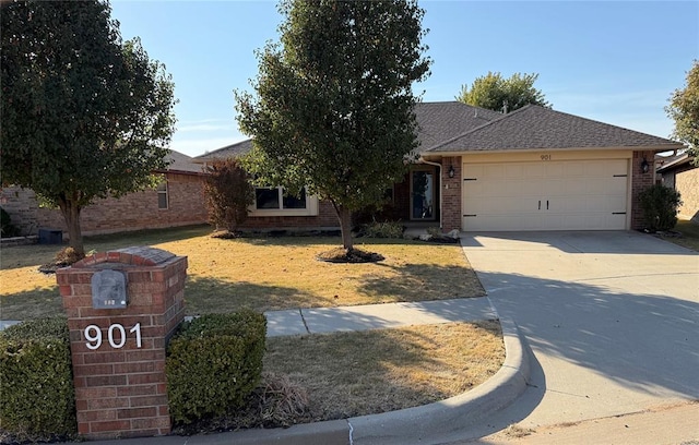 ranch-style house with a garage and a front lawn