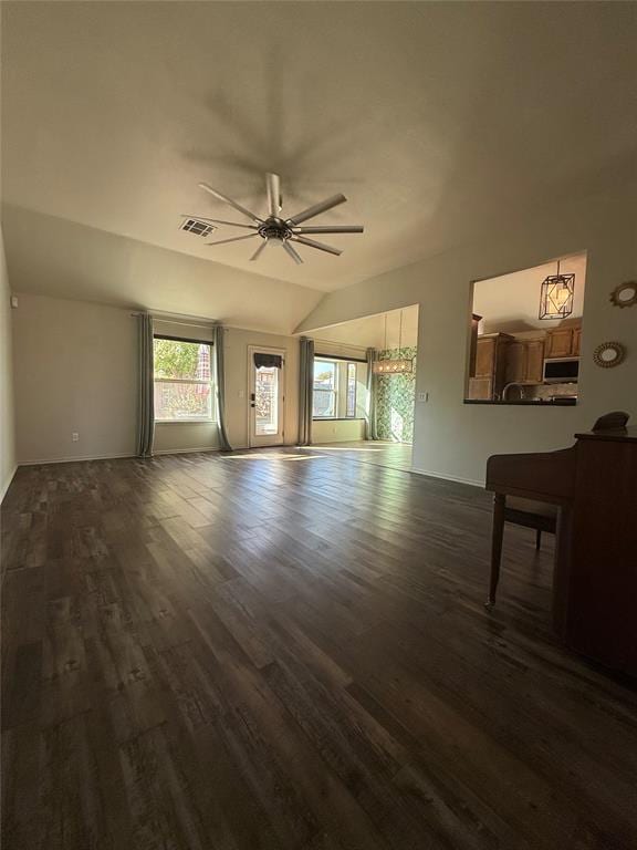 unfurnished living room featuring dark hardwood / wood-style floors and ceiling fan