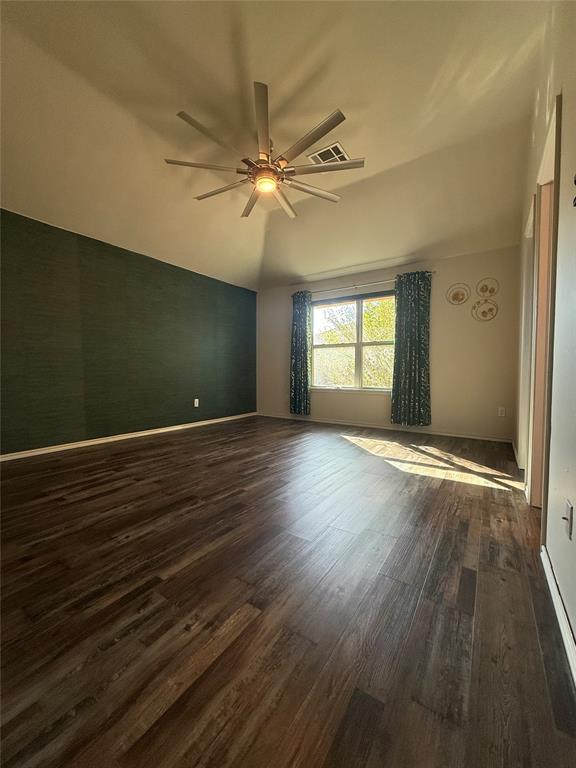 empty room featuring ceiling fan and dark hardwood / wood-style floors