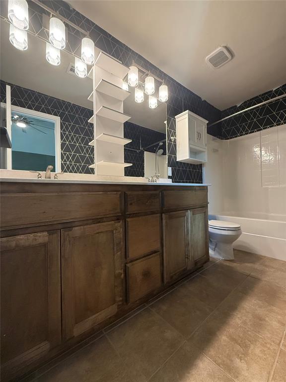 full bathroom featuring vanity, shower / bath combination, and toilet