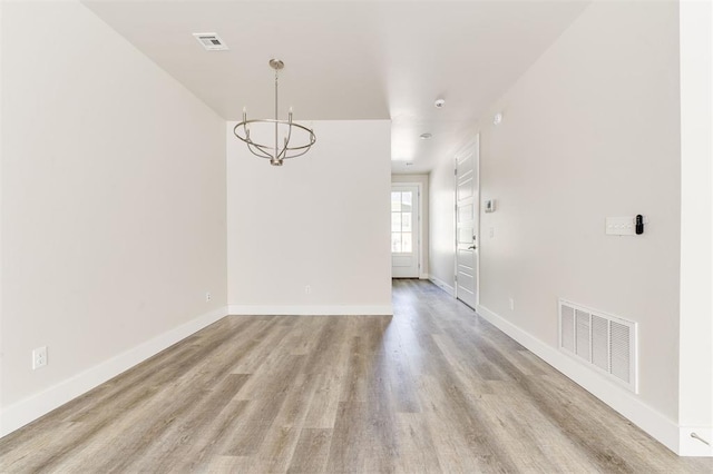 interior space featuring a chandelier and light wood-type flooring