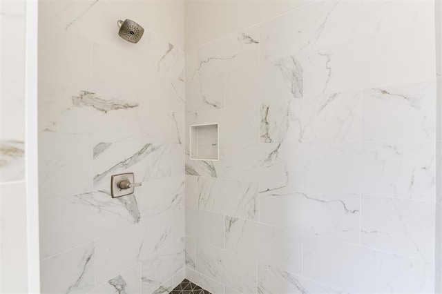 bathroom with a tile shower