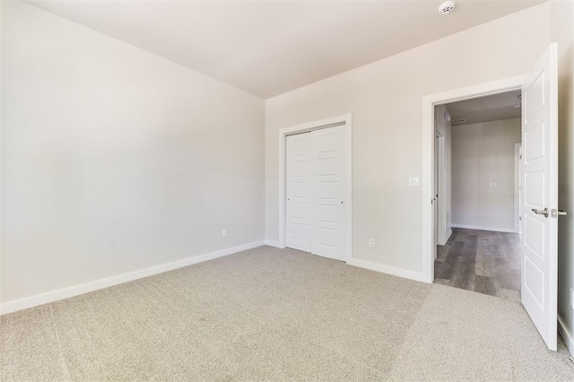 unfurnished bedroom featuring a closet and carpet