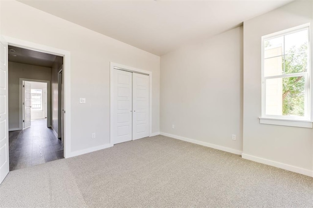 unfurnished bedroom featuring a closet and carpet floors