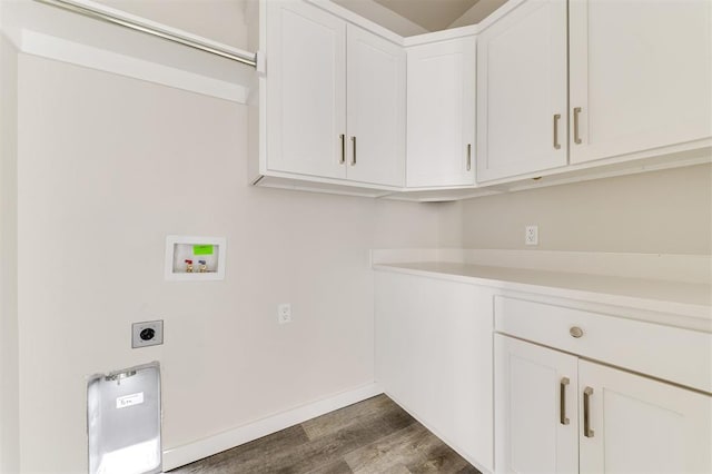 laundry room with electric dryer hookup, hookup for a washing machine, cabinets, and dark hardwood / wood-style floors