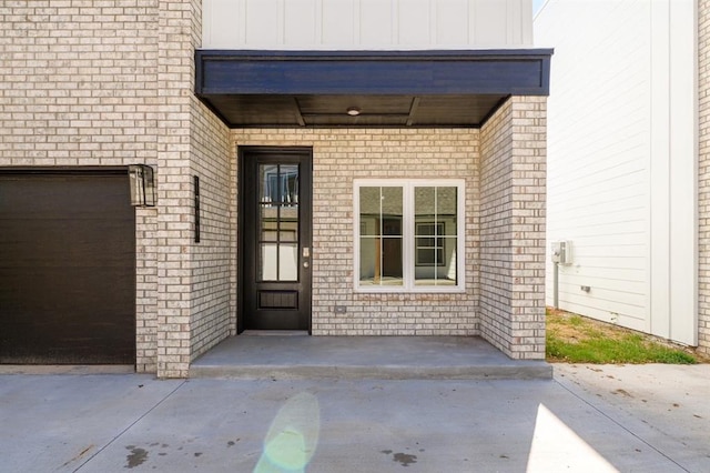 view of exterior entry featuring a garage