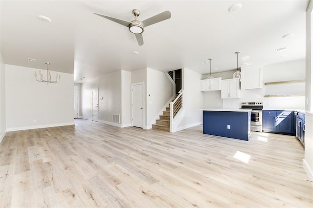 unfurnished living room featuring ceiling fan and light wood-type flooring