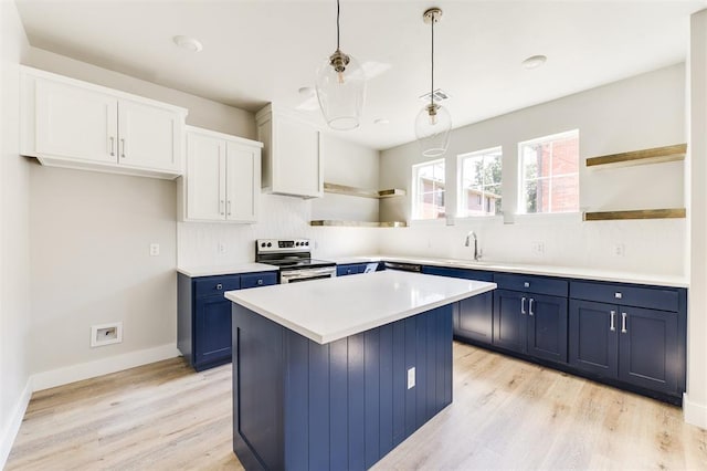 kitchen with light wood-type flooring, electric stove, blue cabinetry, pendant lighting, and white cabinets