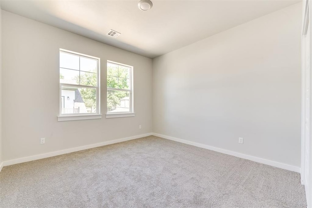 spare room with light colored carpet