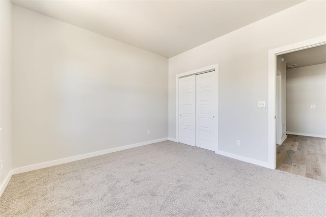 unfurnished bedroom with a closet and carpet floors