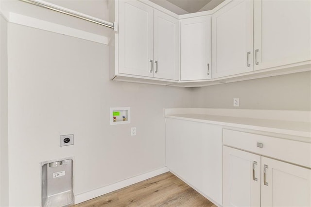 laundry area featuring hookup for an electric dryer, hookup for a washing machine, light wood-type flooring, and cabinets