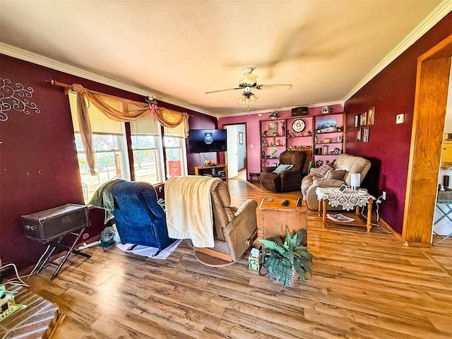 living room with ceiling fan, hardwood / wood-style floors, and ornamental molding