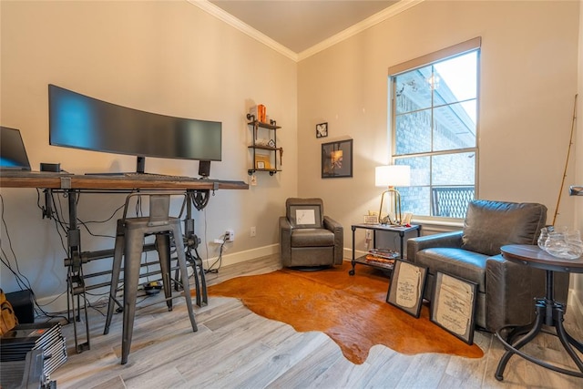 sitting room with light wood-type flooring and ornamental molding