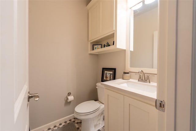 bathroom with tile patterned floors, vanity, and toilet