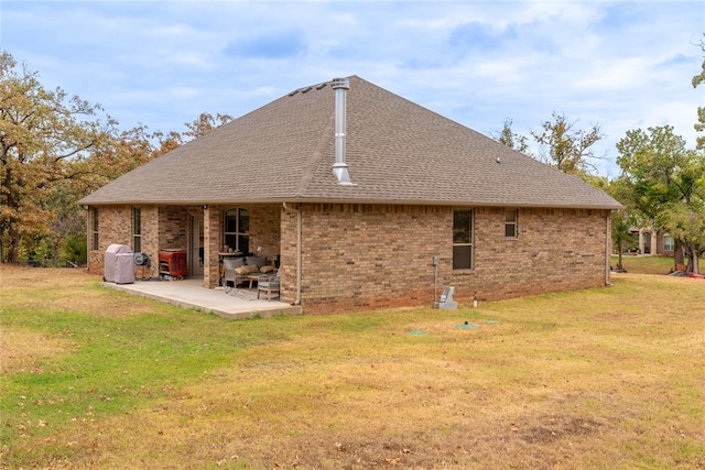 back of house with a yard and a patio