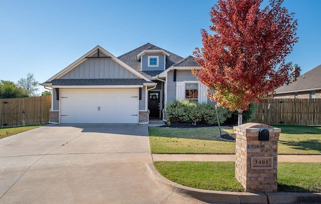 view of front of property featuring a garage and a front lawn