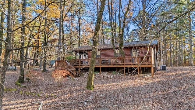 rear view of house featuring a wooden deck and central air condition unit