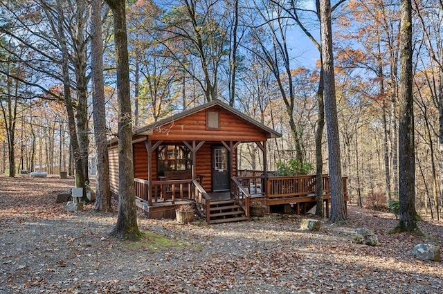 log home featuring a porch