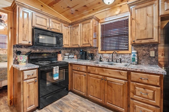 kitchen with sink, wooden ceiling, vaulted ceiling, black appliances, and light wood-type flooring