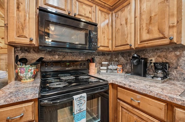 kitchen with decorative backsplash, light stone counters, and black appliances