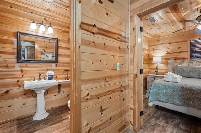 bathroom with hardwood / wood-style floors, ceiling fan, wood walls, and wooden ceiling