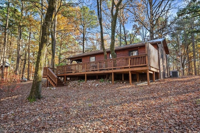 rear view of house featuring central AC unit and a wooden deck