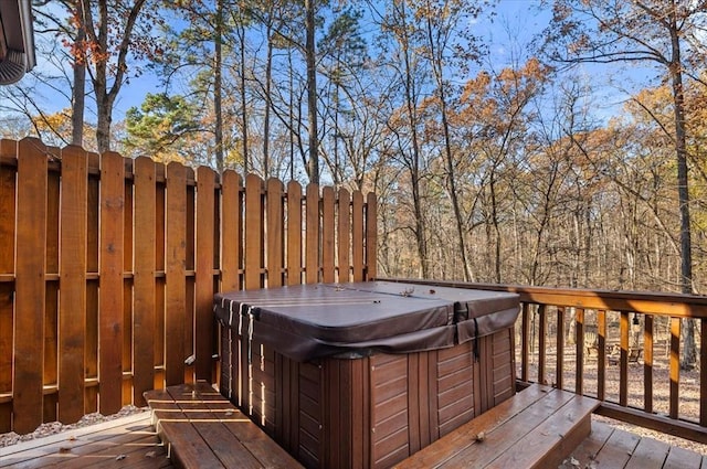 wooden deck featuring a hot tub