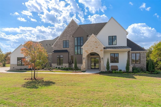 view of front of property featuring a front lawn and french doors