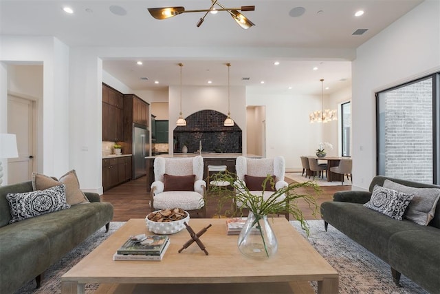 living room with a notable chandelier and dark hardwood / wood-style floors