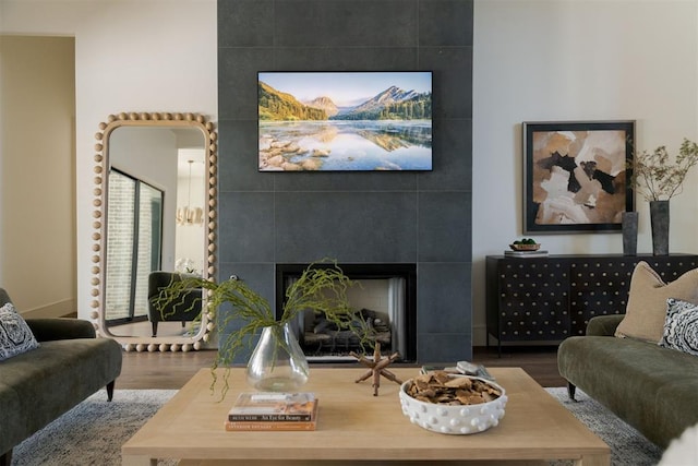 living room with hardwood / wood-style flooring and a tile fireplace