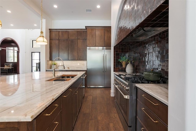 kitchen featuring backsplash, high quality appliances, dark hardwood / wood-style flooring, and sink