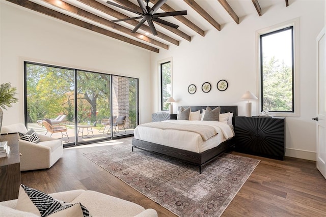 bedroom with beamed ceiling, hardwood / wood-style floors, and access to outside